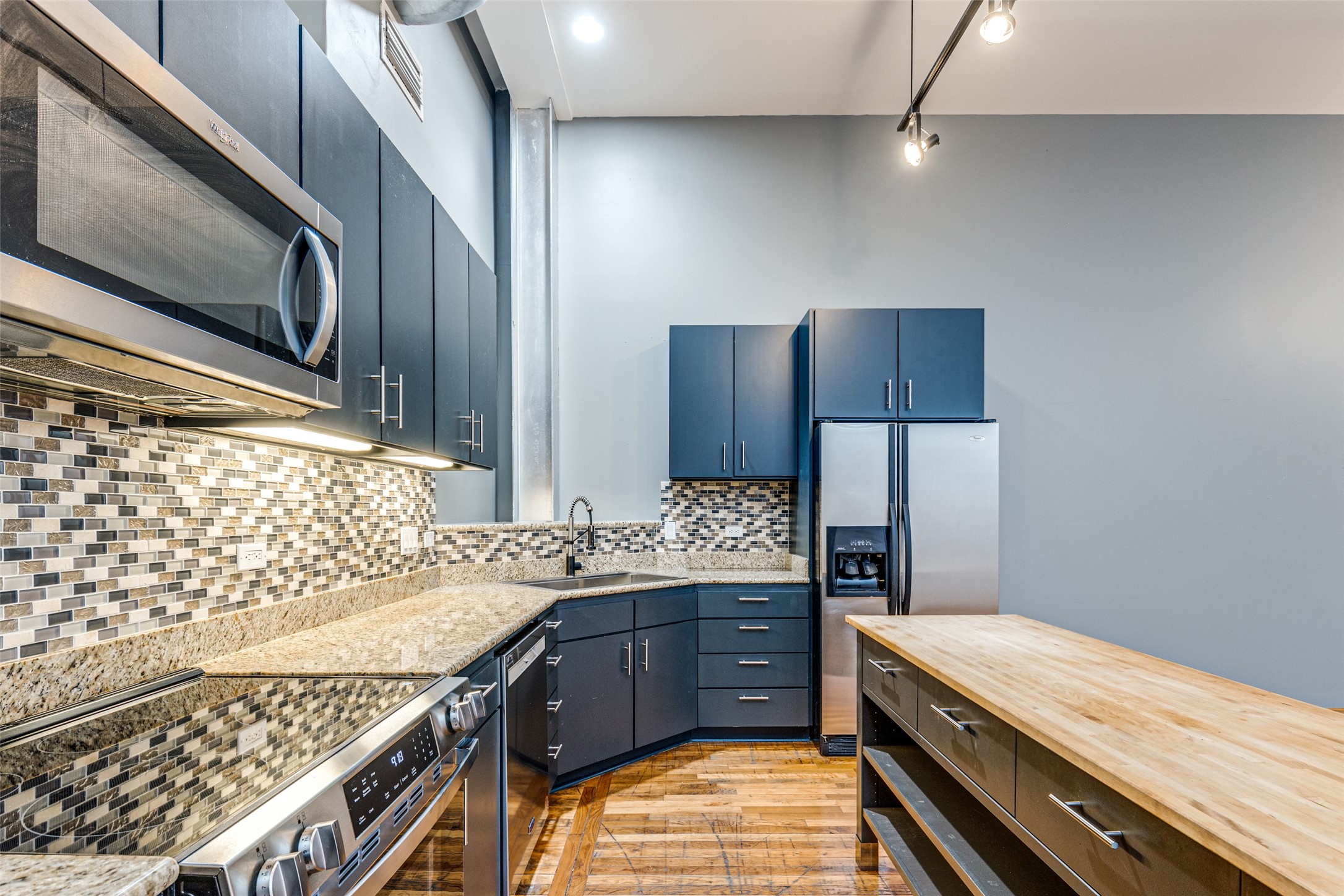 1312 Live Oak Street, Unit 223 Houston, TX 77003 - Photo 9 of 31 Additional kitchen angle highlighting storage, counters, and cohesive design.