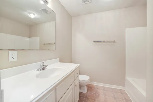 a bathroom with a sink a toilet and vanity