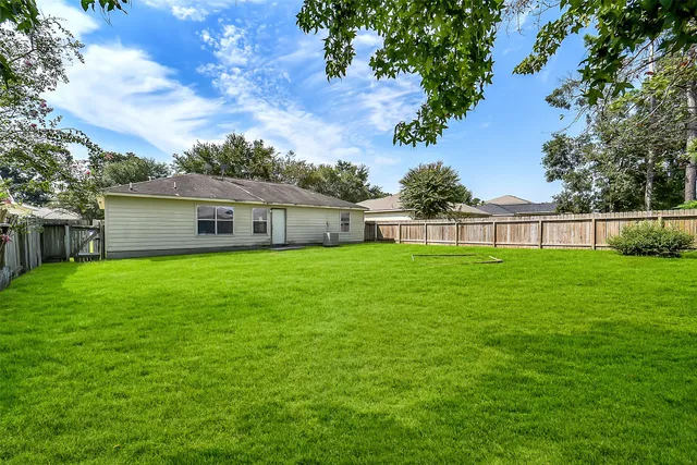 a front view of house with a garden
