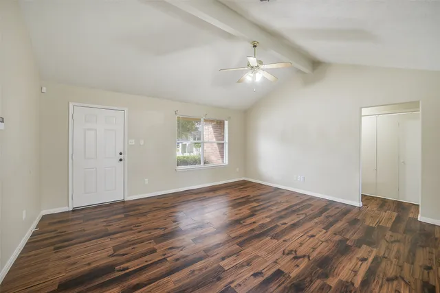 wooden floor in an empty room with a window