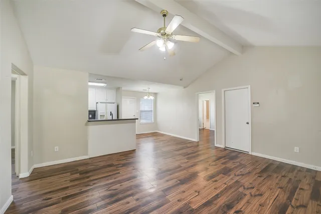 a view of a kitchen with wooden floor and a ceiling fan