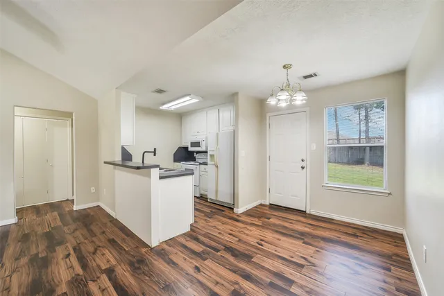 a kitchen with a refrigerator and a sink