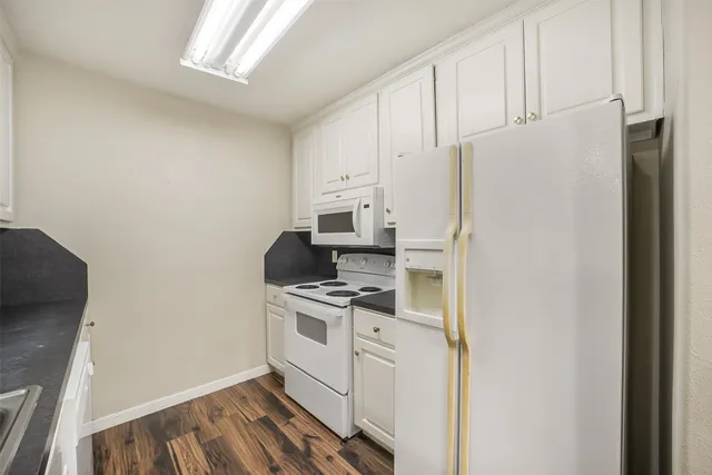 a kitchen with stainless steel appliances a refrigerator a stove a microwave and cabinets