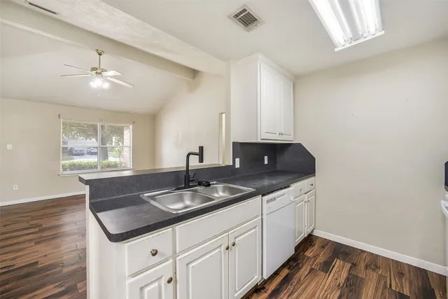a kitchen with a sink and cabinets