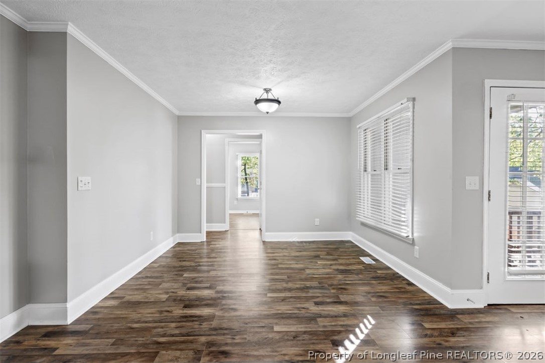 1205 Crossbend Court Fayetteville, NC 28314 - Photo 13 of 37 a view of an empty room with wooden floor and a window
