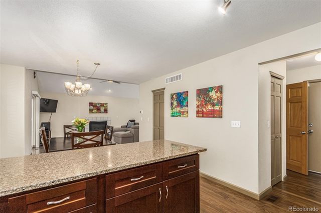 a view of living room with granite countertop cabinets and fireplace