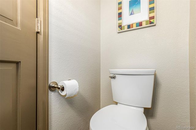 a white toilet sitting next to a bathroom sink