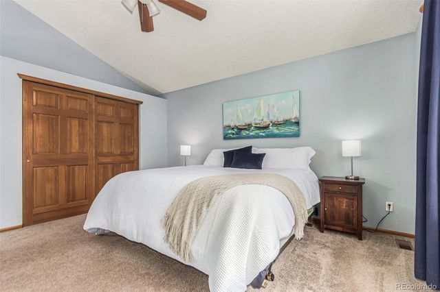 a bedroom with a bed and a painting on the wall