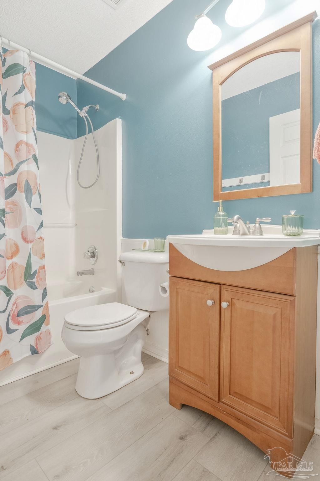 5539 Windrun Place Pace, FL 32571 - Photo 20 of 62 a bathroom with a sink a toilet and shower