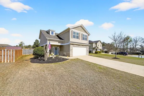 a view of a house with a yard and garage