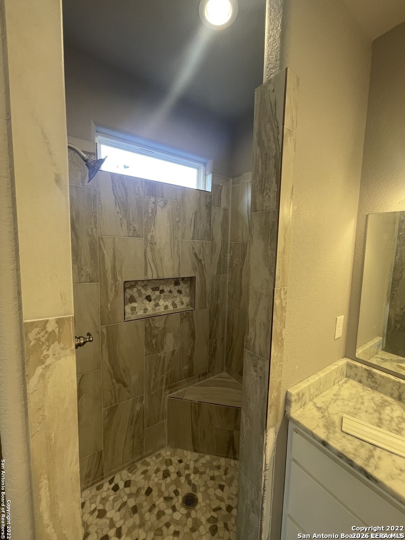 107 Sutton Place Uvalde, TX 78801 - Photo 11 of 11 a bathroom with a granite countertop shower and a sink