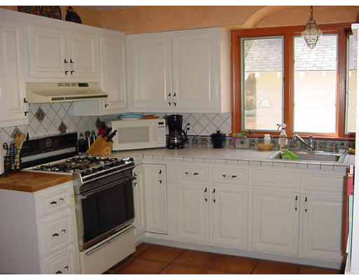2 Florence Road Waltham, MA 02453 - Photo 4 of 13 a kitchen with stainless steel appliances granite countertop a stove a sink and white cabinets