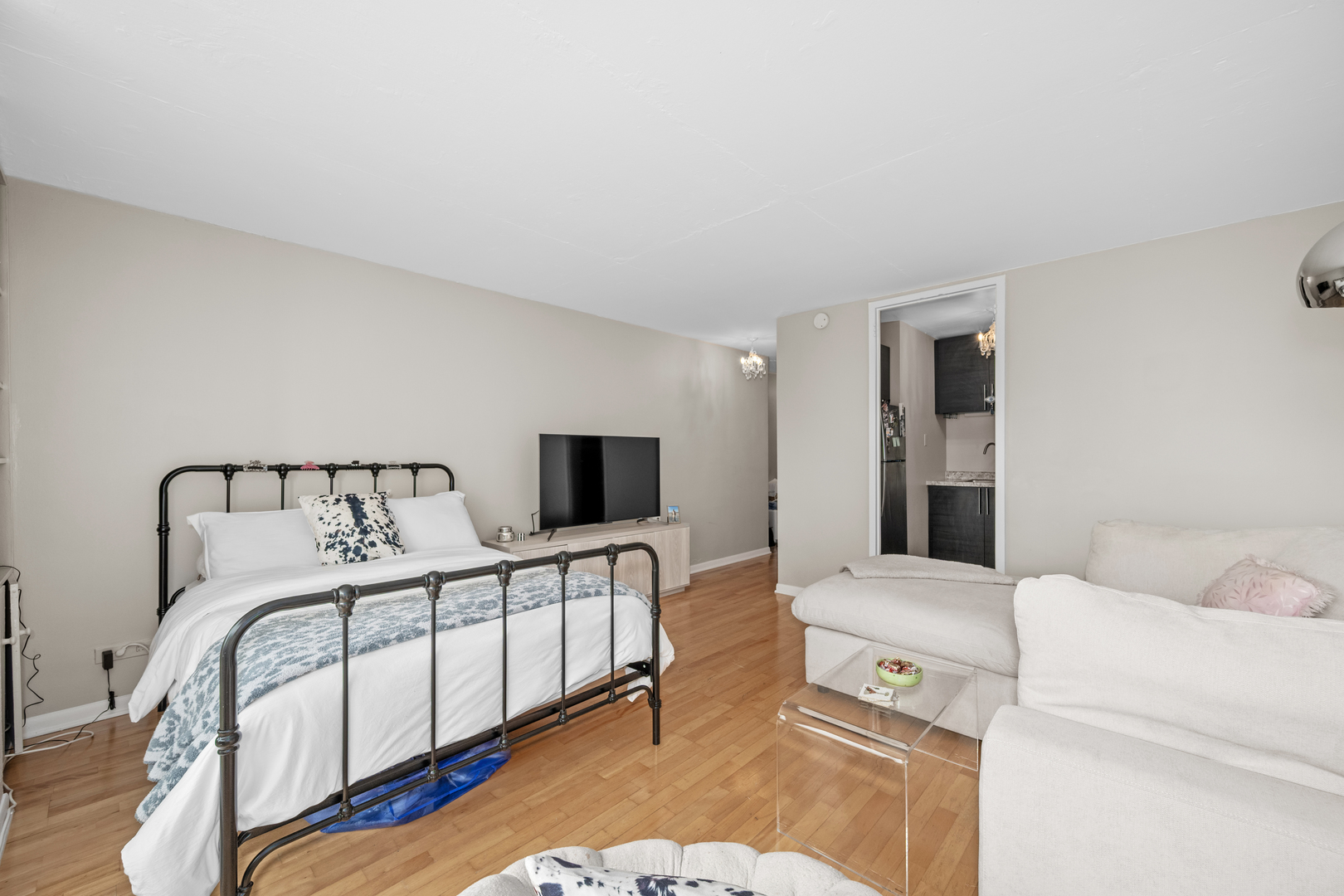 21 West Goethe Street, Unit 16E Chicago, IL 60610 - Photo 7 of 14 a bedroom with a bed and a flat screen tv