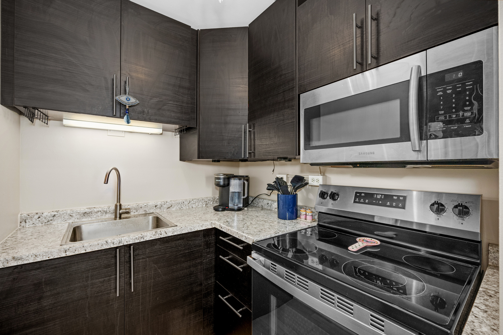 21 West Goethe Street, Unit 16E Chicago, IL 60610 - Photo 9 of 14 a kitchen with a stove microwave and sink
