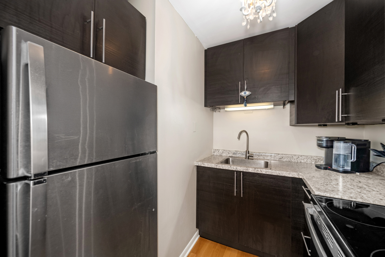 21 West Goethe Street, Unit 16E Chicago, IL 60610 - Photo 10 of 14 a kitchen with a sink and refrigerator