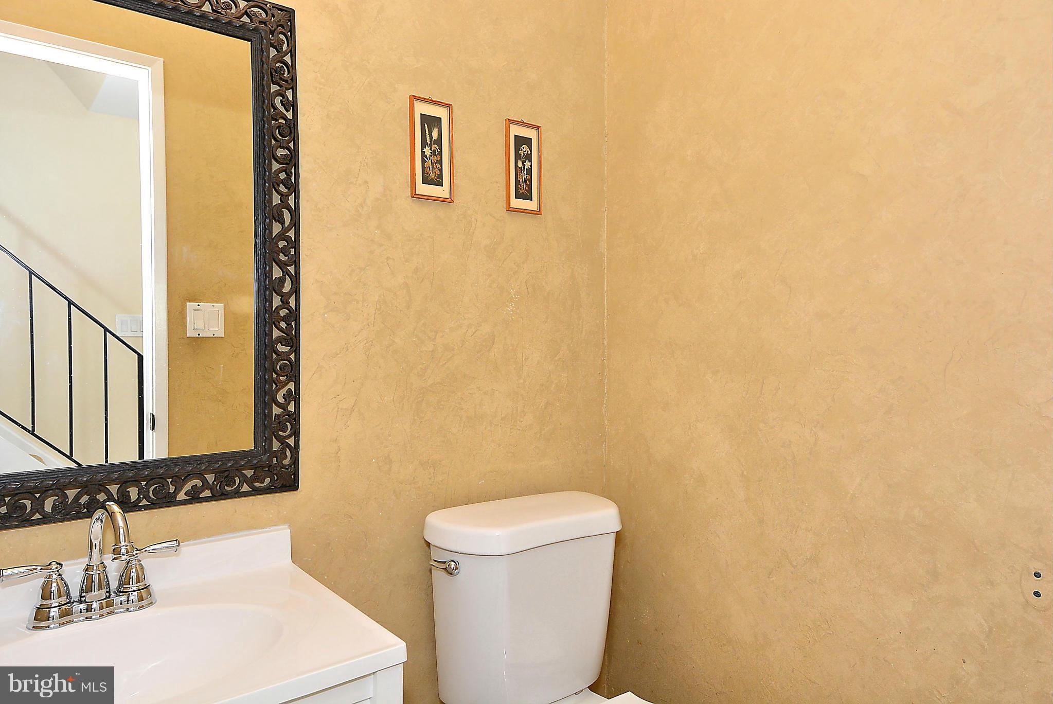 371 Reneau Way Herndon, VA 20170 - Photo 12 of 30 a bathroom with a sink a toilet and a mirror
