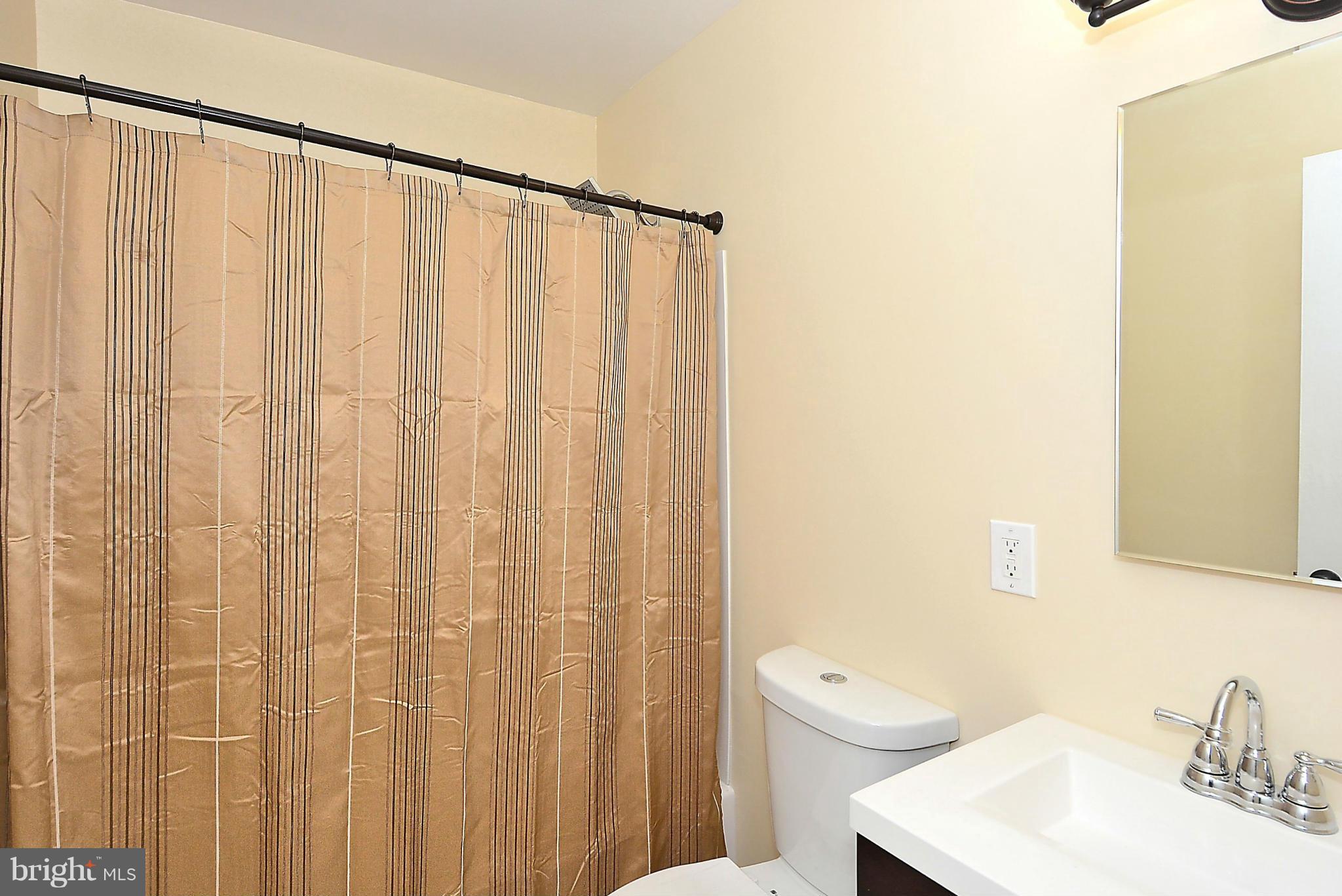 371 Reneau Way Herndon, VA 20170 - Photo 17 of 30 a bathroom with a shower curtain and a sink