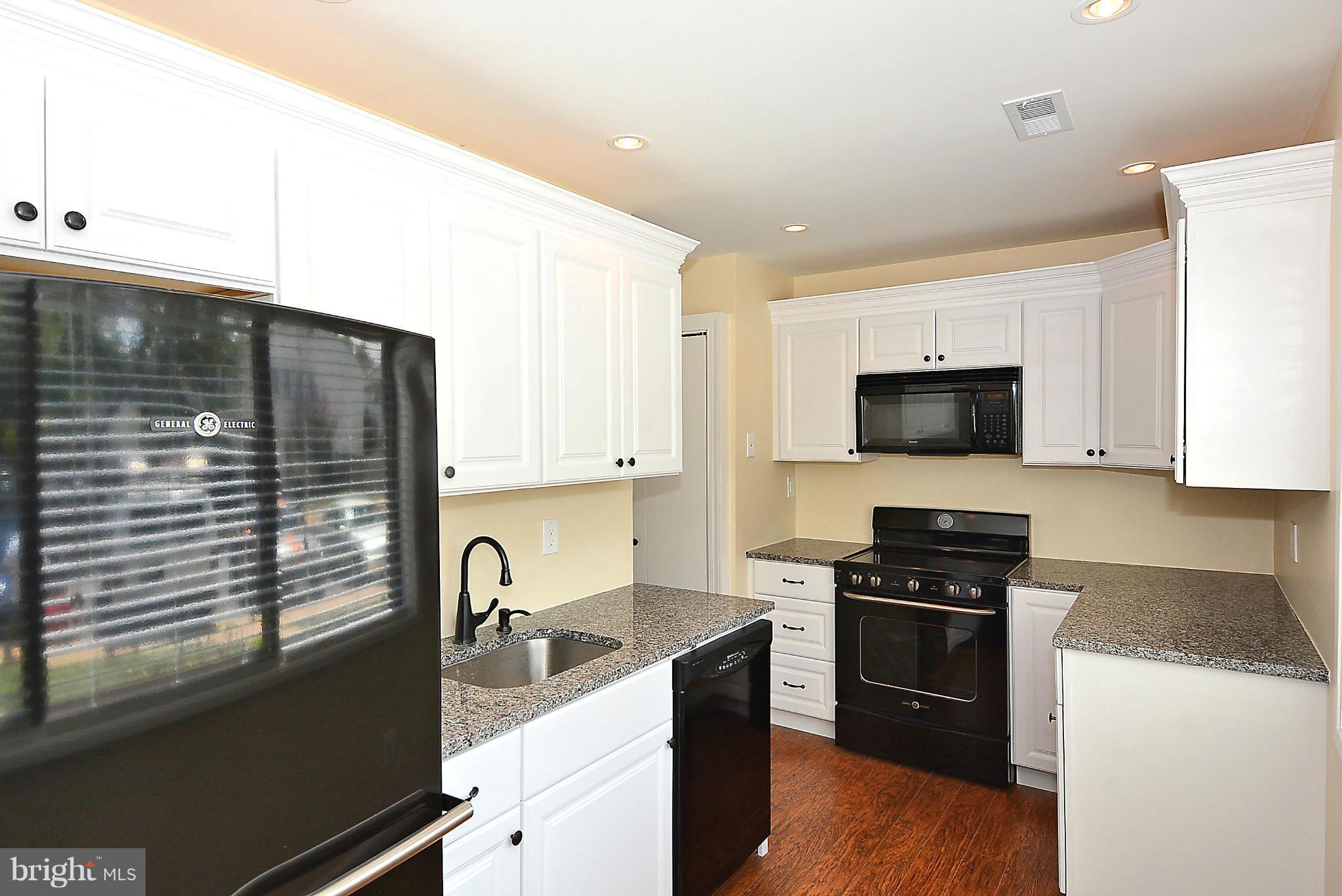 371 Reneau Way Herndon, VA 20170 - Photo 3 of 30 a kitchen with stainless steel appliances a stove sink and microwave