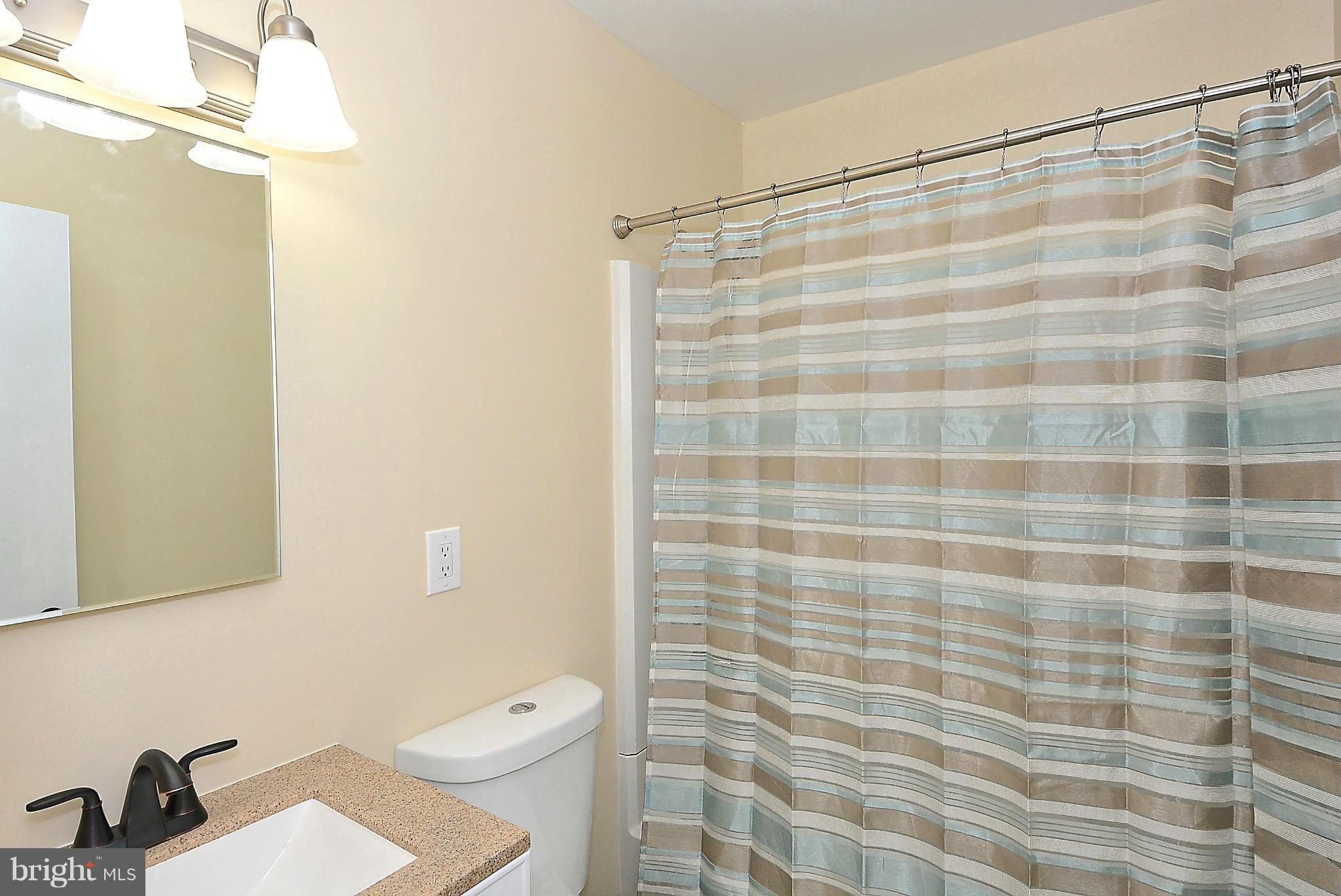 371 Reneau Way Herndon, VA 20170 - Photo 23 of 30 a bathroom with a shower curtain and a sink