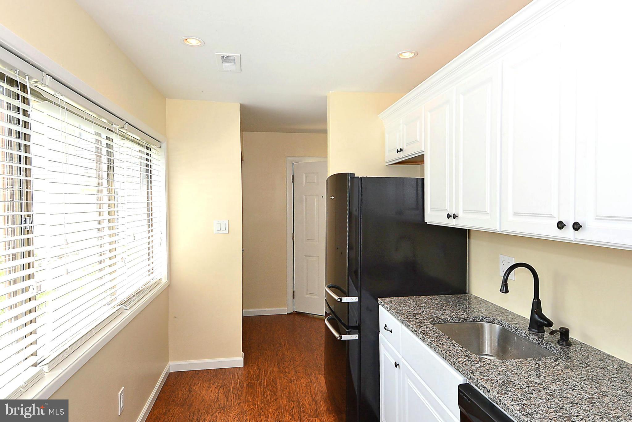 371 Reneau Way Herndon, VA 20170 - Photo 4 of 30 a kitchen with granite countertop a refrigerator and a sink