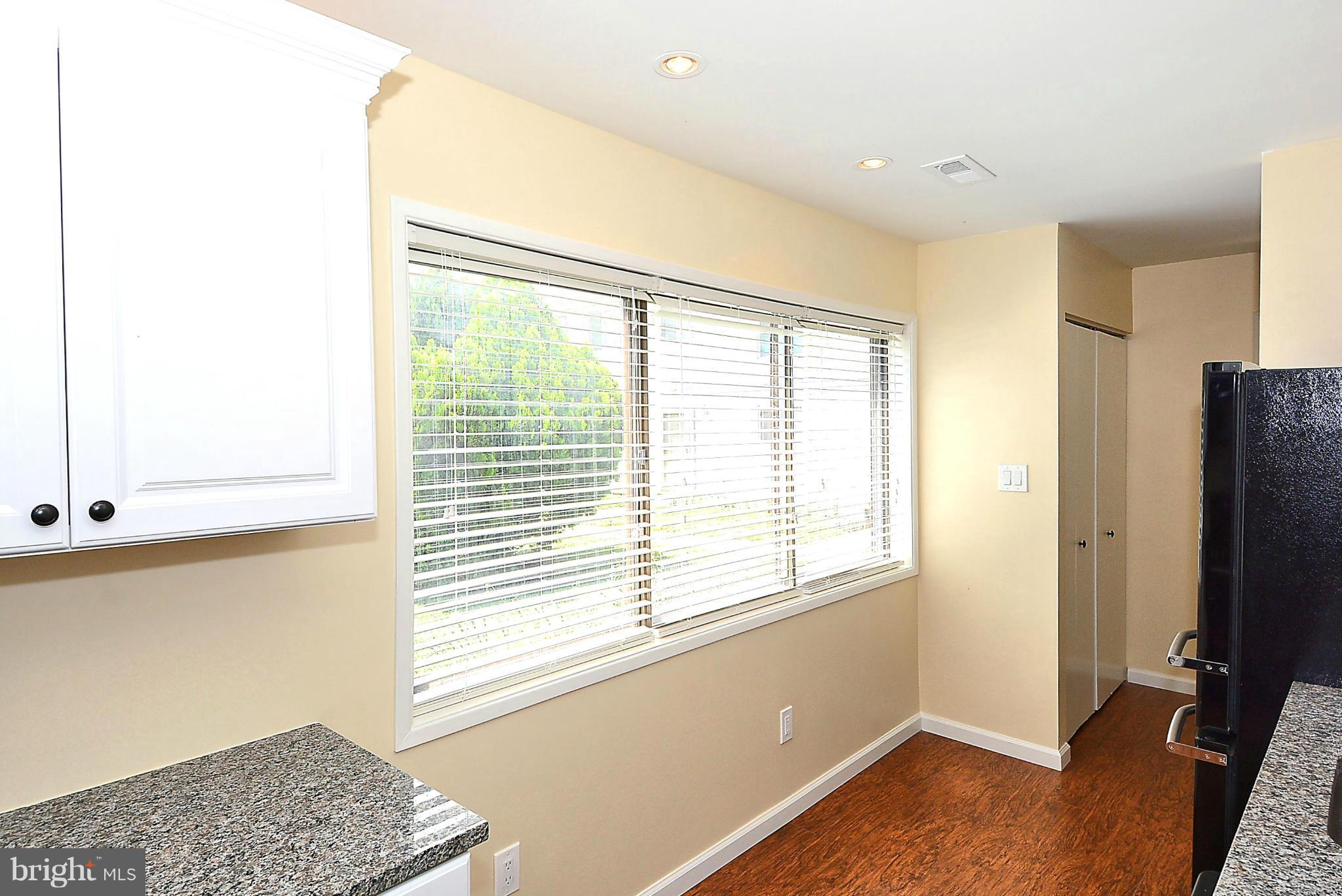 371 Reneau Way Herndon, VA 20170 - Photo 5 of 30 a view of an empty room with a window and wooden floor