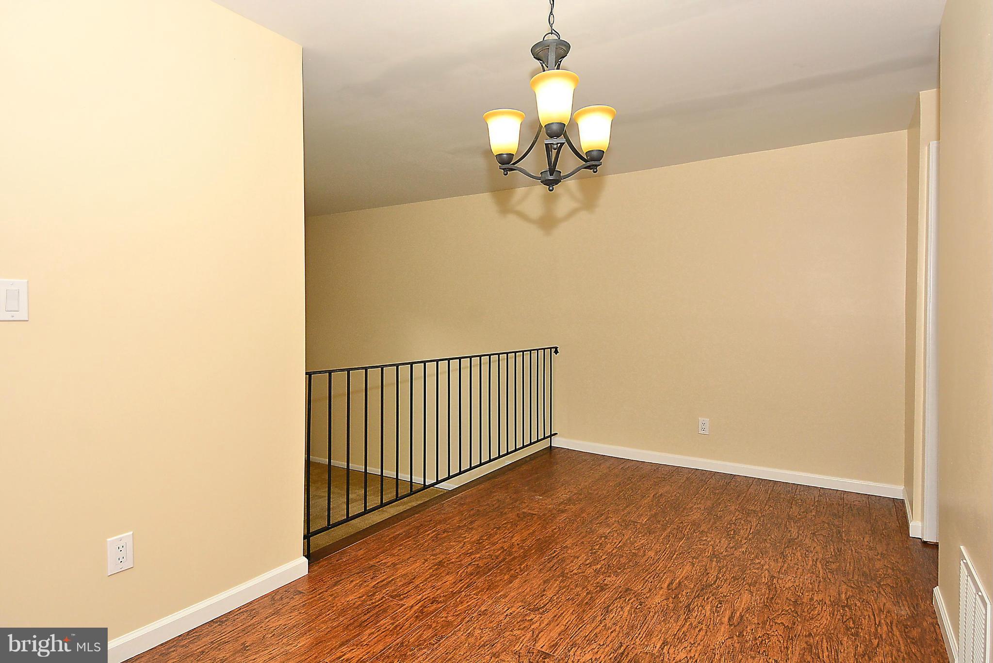 371 Reneau Way Herndon, VA 20170 - Photo 8 of 30 a view of a chandelier fan and wooden floor