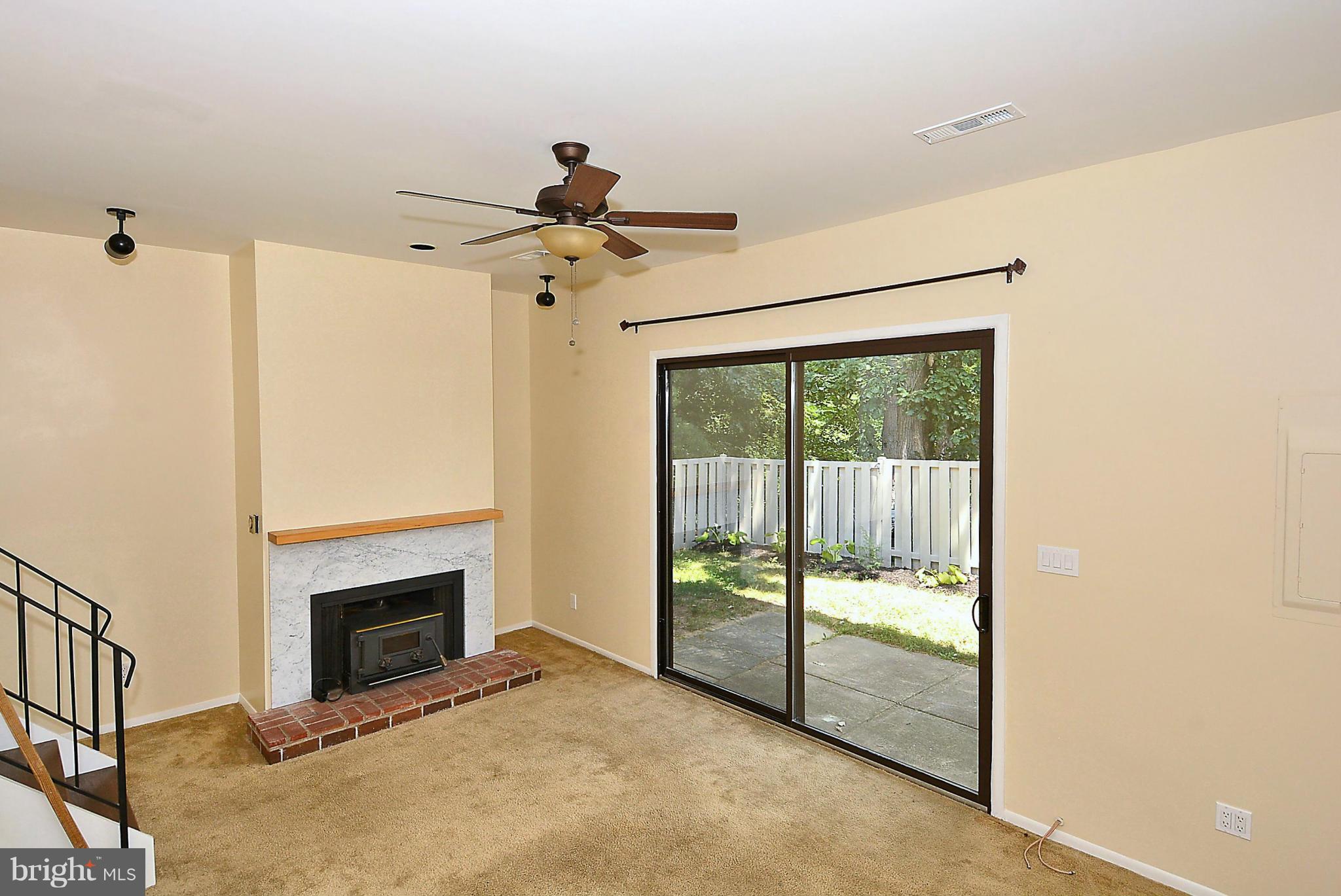 371 Reneau Way Herndon, VA 20170 - Photo 9 of 30 a view of a livingroom with a fireplace and a ceiling fan