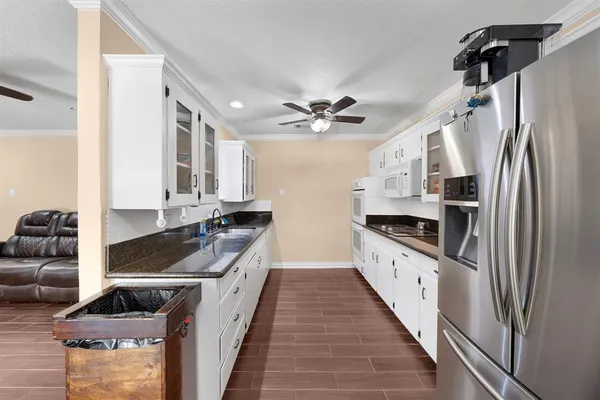 a kitchen with stainless steel appliances granite countertop a stove a sink and a refrigerator