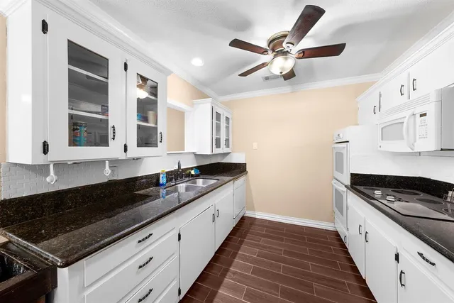 a kitchen with stainless steel appliances granite countertop a sink and cabinets