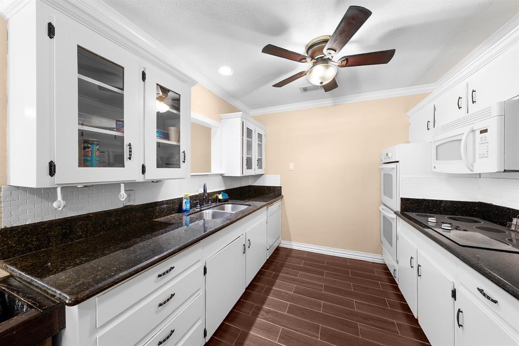 1075 Oak Ridge Drive Terrell, TX 75160 - Photo 13 of 28 a kitchen with stainless steel appliances granite countertop a sink and cabinets