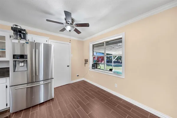 a kitchen with stainless steel appliances a refrigerator and a window