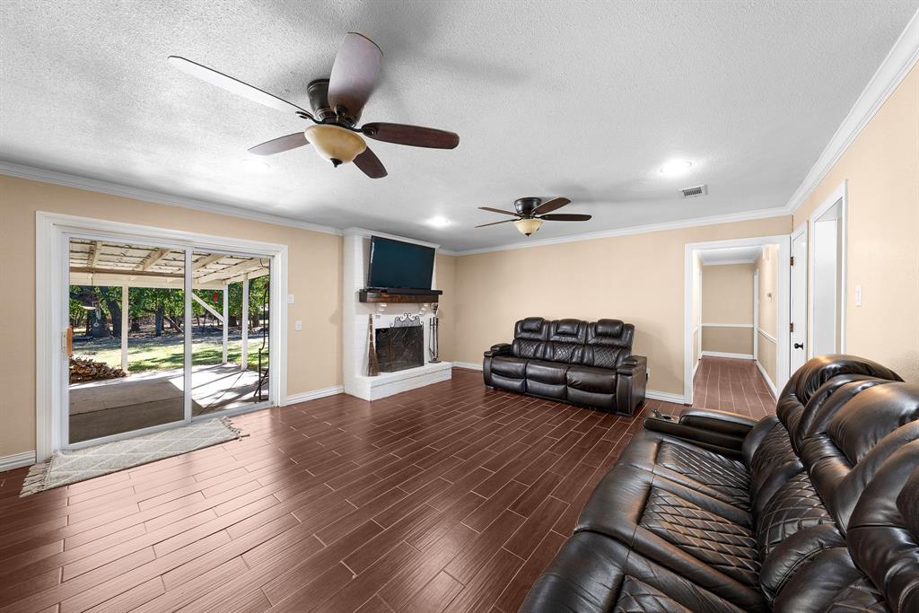 1075 Oak Ridge Drive Terrell, TX 75160 - Photo 16 of 28 a living room with furniture windows and a fireplace