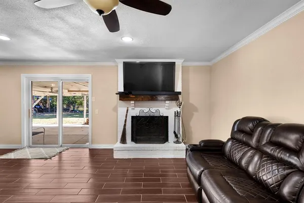 a living room with furniture flat screen tv and a fireplace