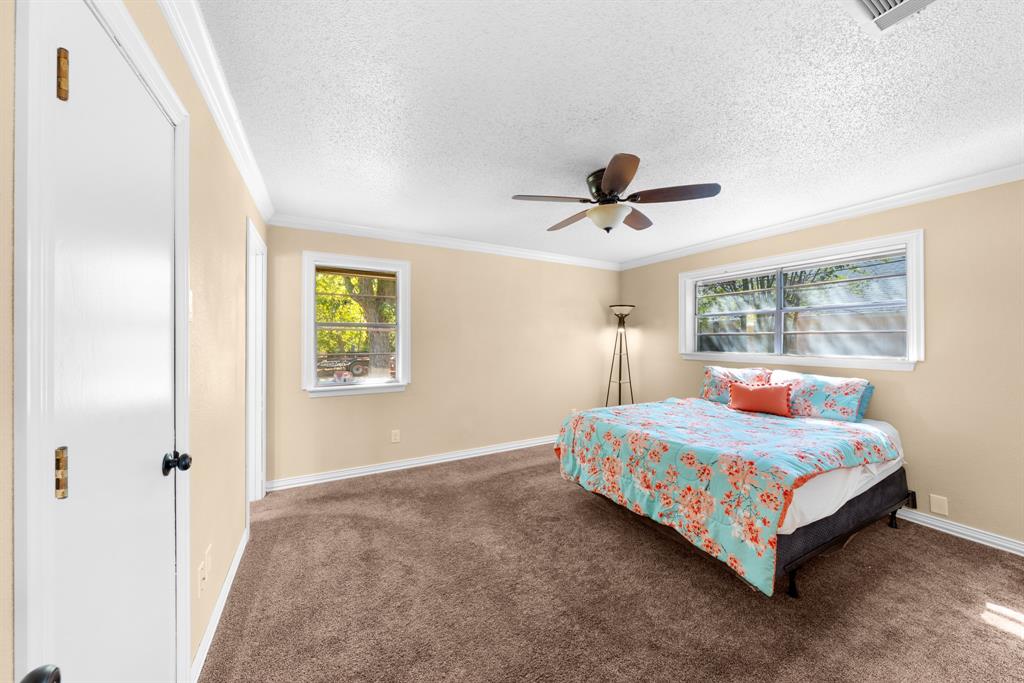 1075 Oak Ridge Drive Terrell, TX 75160 - Photo 24 of 28 a room with a bed and a ceiling fan