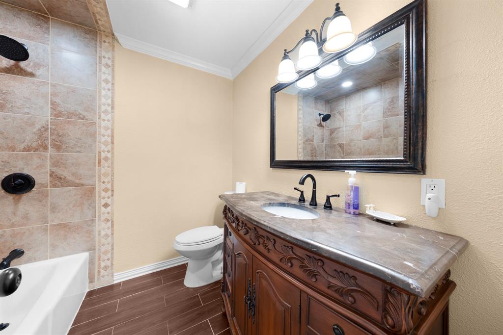 1075 Oak Ridge Drive Terrell, TX 75160 - Photo 26 of 28 a bathroom with a sink a toilet and shower