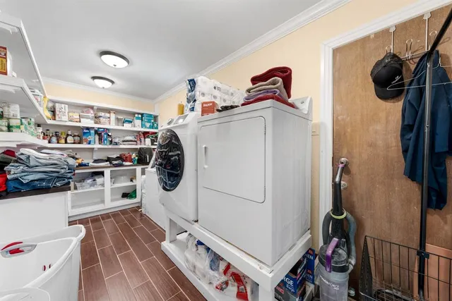 a utility room with cabinets washer and dryer