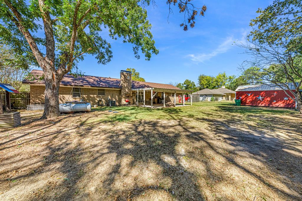 1075 Oak Ridge Drive Terrell, TX 75160 - Photo 3 of 28 a front view of a house with large garden
