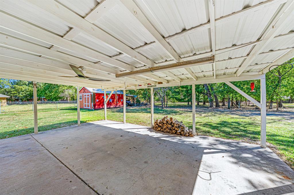 1075 Oak Ridge Drive Terrell, TX 75160 - Photo 7 of 28 a view of a backyard with plants and porch with a table