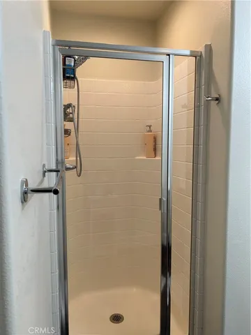 a bathroom with a glass shower door