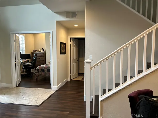 a view of entryway and hall with wooden floor