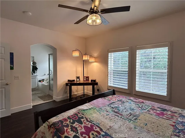 a bedroom with a bed a window and walk in closet