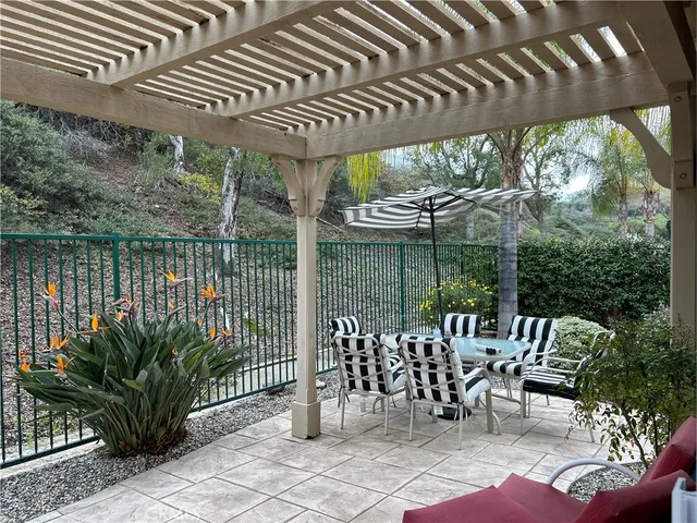 a view of a chairs and table in patio with a small yard