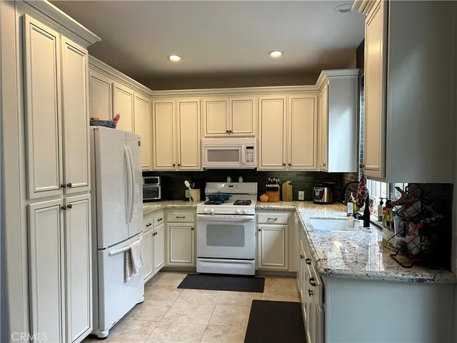 a kitchen with a refrigerator and a sink