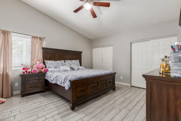 a room with a bed and a dresser