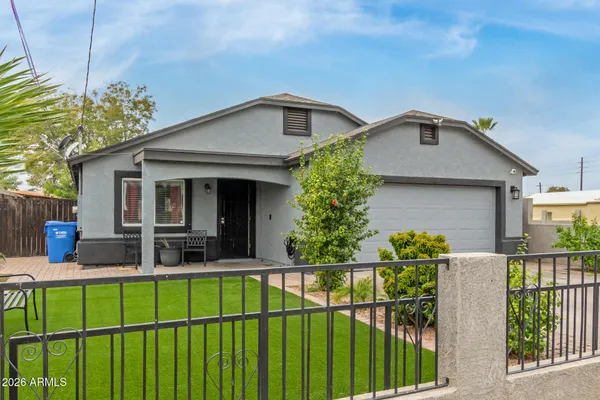 a front view of house along with deck and outdoor seating