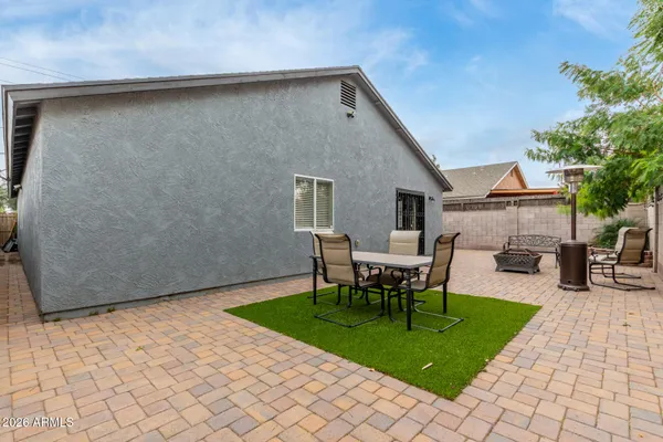 a view of a backyard with table and chairs