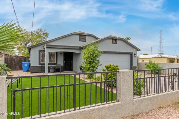 a front view of a house with wooden fence