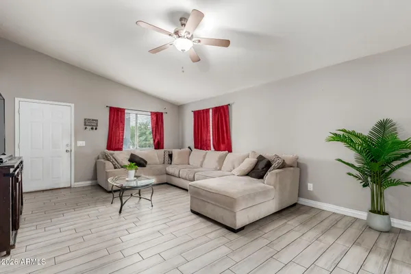 a living room with furniture and a potted plant