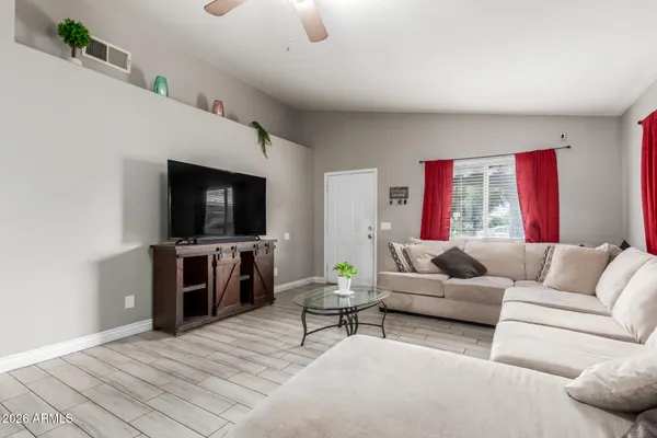 a living room with furniture and a flat screen tv