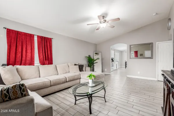 a living room with furniture and a chandelier